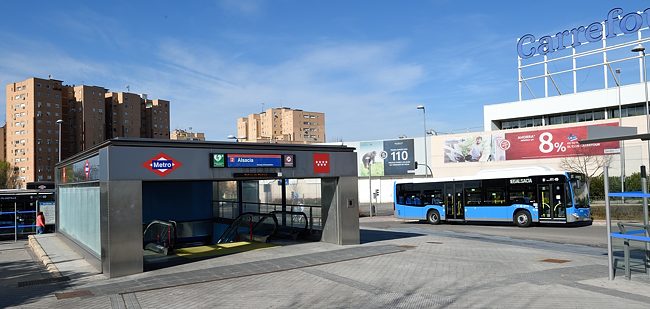 Bus passes Alsacia metro station in Madrid, Spain